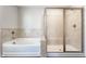 Corner tub and standing shower with sliding glass doors in main bathroom at 6408 Askin Dr, Indianapolis, IN 46259