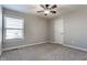 Bedroom featuring a window, ceiling fan and neutral carpet, offering a comfortable space at 6408 Askin Dr, Indianapolis, IN 46259