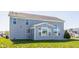 Back exterior of a two-story home with gray siding, a sunroom and large windows overlooking the backyard at 6408 Askin Dr, Indianapolis, IN 46259