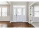 Bright foyer features hardwood floors, natural light, and a glass front door at 6408 Askin Dr, Indianapolis, IN 46259