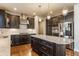 Gourmet kitchen featuring dark cabinetry, a large island, and stainless steel appliances at 6408 Askin Dr, Indianapolis, IN 46259