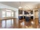 Stylish kitchen with hardwood floors, dark cabinets, and a large island at 6408 Askin Dr, Indianapolis, IN 46259