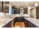 Well-lit kitchen showcasing granite countertops, tile backsplash, and dark wood cabinetry at 6408 Askin Dr, Indianapolis, IN 46259