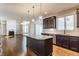 Open-concept kitchen with stainless steel appliances, granite countertops, and hardwood floors at 6408 Askin Dr, Indianapolis, IN 46259