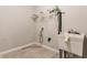 Practical laundry room with vinyl floors, utility sink, and wire shelving at 6408 Askin Dr, Indianapolis, IN 46259