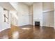 Bright living room with a fireplace, hardwood flooring, and an open staircase at 6408 Askin Dr, Indianapolis, IN 46259