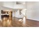 Open living room with hardwood floors flowing into kitchen with dark cabinetry at 6408 Askin Dr, Indianapolis, IN 46259