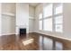 Spacious living room featuring a fireplace, hardwood floors, and oversized windows at 6408 Askin Dr, Indianapolis, IN 46259