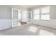 Sunlit living room features plush carpeting and french doors at 6408 Askin Dr, Indianapolis, IN 46259