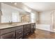 Bright bathroom featuring dual sinks, ample countertop space, and a separate shower and tub at 6408 Askin Dr, Indianapolis, IN 46259