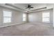 Large main bedroom featuring tray ceilings, carpet, and multiple bright windows at 6408 Askin Dr, Indianapolis, IN 46259