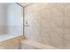 Close up of beige shower tiling and a built-in shower bench at 6408 Askin Dr, Indianapolis, IN 46259