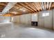 Spacious unfinished basement with exposed beams and a modern fireplace at 6519 Rothchild Blvd, Indianapolis, IN 46278