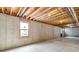 Unfinished basement with a window and exposed ceiling beams at 6519 Rothchild Blvd, Indianapolis, IN 46278
