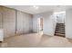 Unfinished basement with concrete wall, exposed utilities, and stairs at 6519 Rothchild Blvd, Indianapolis, IN 46278