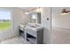 Bathroom with a double vanity, tile flooring, and a large window at 6519 Rothchild Blvd, Indianapolis, IN 46278