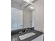 Contemporary bathroom featuring a dark granite-topped vanity, sleek mirror, and modern fixtures at 6519 Rothchild Blvd, Indianapolis, IN 46278