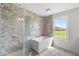 Bathroom with a standalone tub and a tiled shower at 6519 Rothchild Blvd, Indianapolis, IN 46278