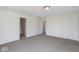 Carpeted bedroom with multiple doorways and neutral color scheme at 6519 Rothchild Blvd, Indianapolis, IN 46278