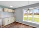 Dining area with built-in cabinets, a large window, and elegant lighting at 6519 Rothchild Blvd, Indianapolis, IN 46278