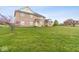 Charming brick home with large front yard and mature landscaping at 6519 Rothchild Blvd, Indianapolis, IN 46278