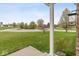 Landscaped front yard with lush green lawn and mature trees creates a welcoming curb appeal at 6519 Rothchild Blvd, Indianapolis, IN 46278