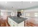 Open kitchen with a large island, hardwood floors, and an eat-in dining area at 6519 Rothchild Blvd, Indianapolis, IN 46278