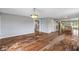An open-concept living room with hardwood floors connecting to the kitchen and staircase at 6519 Rothchild Blvd, Indianapolis, IN 46278