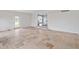 Bright and airy living room featuring tiled floors, a walkout door, and an open transition to another room at 6519 Rothchild Blvd, Indianapolis, IN 46278