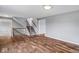 Bright living room features hardwood floors, staircase, and neutral paint at 6519 Rothchild Blvd, Indianapolis, IN 46278