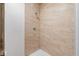 Shower stall featuring earth-toned tiling and modern fixtures at 6519 Rothchild Blvd, Indianapolis, IN 46278
