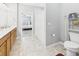 Bathroom featuring a wood vanity, neutral flooring, and a separated toilet area at 6606 Colt Ln, Anderson, IN 46013