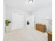 Light-filled bedroom with carpet, featuring closet, open door, and neutral tones at 6606 Colt Ln, Anderson, IN 46013