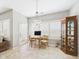 Bright dining area features large windows, a chandelier and a beautiful china cabinet for displaying decor at 6606 Colt Ln, Anderson, IN 46013