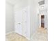 Hallway view includes a set of double doors and leads to the garage providing easy access at 6606 Colt Ln, Anderson, IN 46013