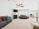 Bright and open living room with a fireplace, ceiling fan, and lots of space for relaxing and entertaining guests at 6606 Colt Ln, Anderson, IN 46013