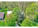 Aerial view of a home surrounded by mature trees and lush landscaping on a sunny day at 70 Williamsburg Ct, Zionsville, IN 46077