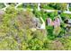 A stunning aerial view of a home featuring lush green lawns, mature trees, and beautiful landscaping on a sunny day at 70 Williamsburg Ct, Zionsville, IN 46077