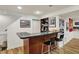Basement bar area with a countertop and chairs, perfect for entertaining at 70 Williamsburg Ct, Zionsville, IN 46077