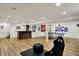 Finished basement with a ping pong table, bar area, and wood flooring at 70 Williamsburg Ct, Zionsville, IN 46077
