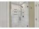 Modern bathroom shower with white tile and glass door at 70 Williamsburg Ct, Zionsville, IN 46077