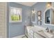 Elegant bathroom with double sink vanity, framed mirrors, and updated fixtures at 70 Williamsburg Ct, Zionsville, IN 46077