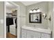 Bright bathroom with white marble countertops and a view into a walk-in closet at 70 Williamsburg Ct, Zionsville, IN 46077