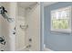 Clean bathroom with a shower/tub, white subway tile, and window with natural light at 70 Williamsburg Ct, Zionsville, IN 46077