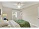 Cozy bedroom featuring a ceiling fan, window, and closet with green comforter at 70 Williamsburg Ct, Zionsville, IN 46077