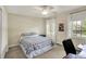 Comfortable bedroom with a ceiling fan, carpet, and two windows for natural light at 70 Williamsburg Ct, Zionsville, IN 46077