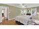 Light-filled bedroom with wooden floors, windows, and a doorway to another room at 70 Williamsburg Ct, Zionsville, IN 46077