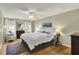 Bright bedroom featuring hardwood floors, large windows, ceiling fan and neutral paint at 70 Williamsburg Ct, Zionsville, IN 46077