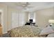 Bright carpeted bedroom with closet, ceiling fan, window, and desk area at 70 Williamsburg Ct, Zionsville, IN 46077