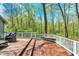 Outdoor deck area complete with seating, overlooking the wooded back yard at 70 Williamsburg Ct, Zionsville, IN 46077
